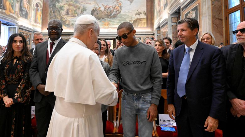 Pope Leo shakes hands with American singer Pharrell Williams during an audience with participants of the "World Meeting on Human Fraternity" at the Vatican, September 12, 2025.