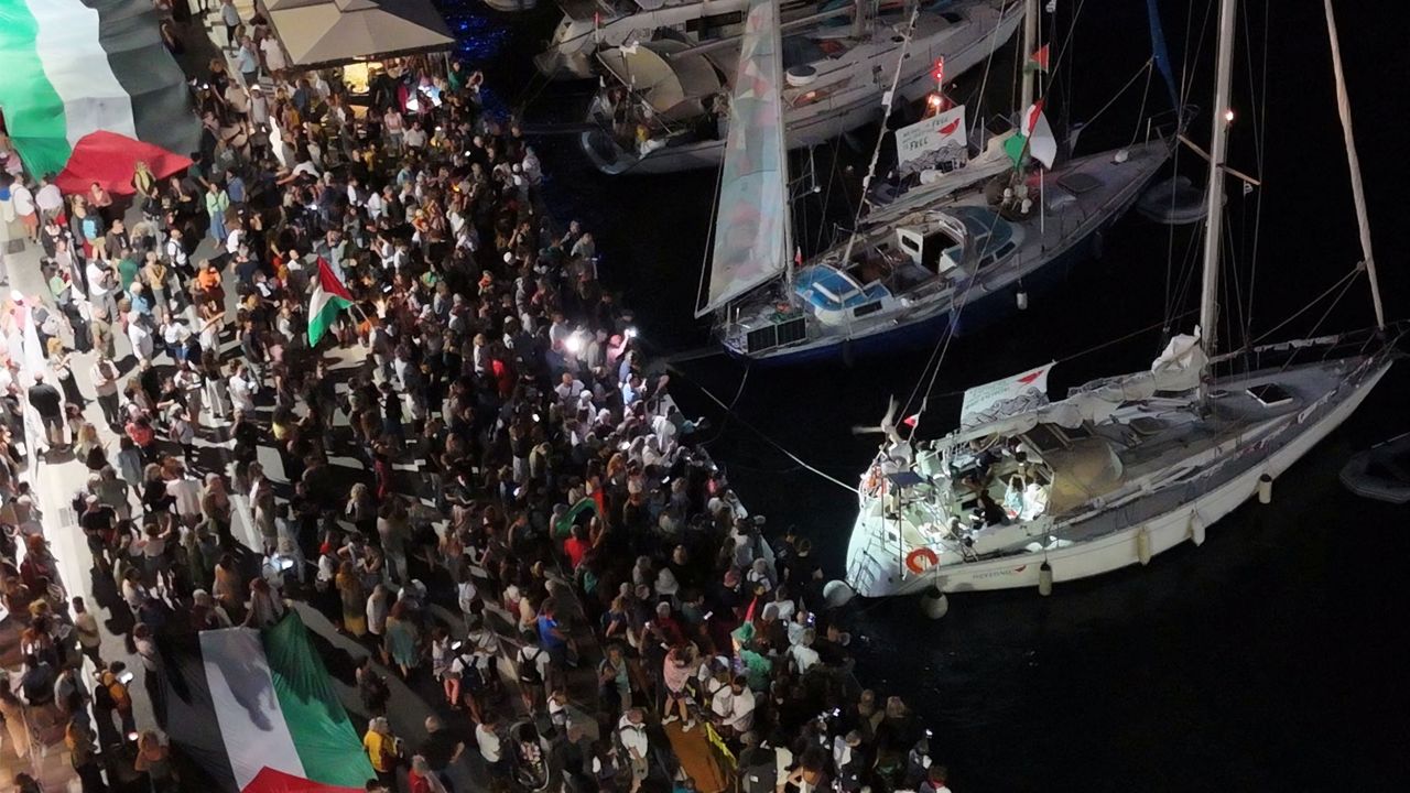 A screenshot from a drone video shows people gathering at a Greek port before the departure of two boats taking part in the Global Sumud Flotilla on September 14.