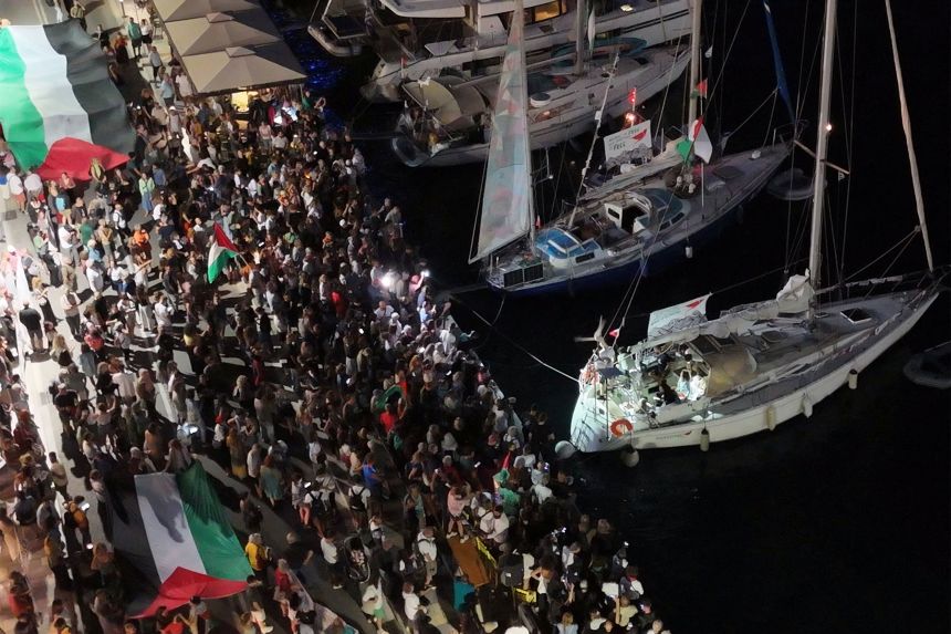 A screenshot from a drone video shows people gathering at a Greek port before the departure of two boats taking part in the Global Sumud Flotilla on September 14.