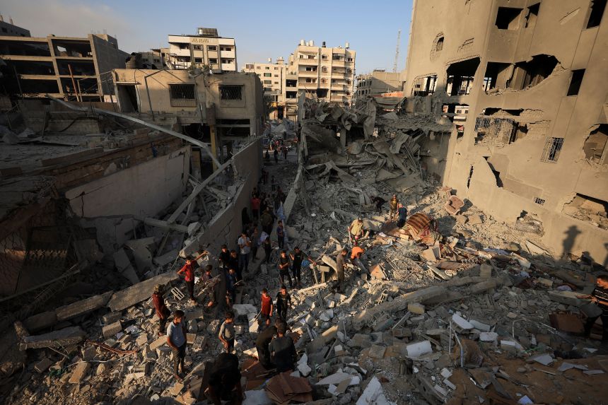 Palestinians will inspect the damage on the Israeli strike site that destroyed the Al-Yundi Al-Majaur residential tower on Sunday in Gaza city on September 15, 2025.