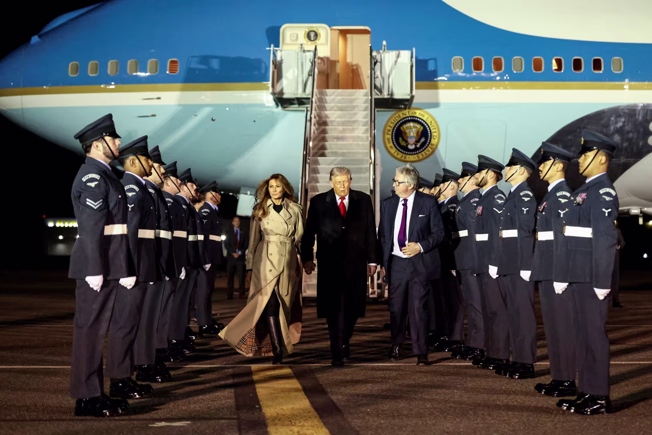 President Donald Trump walks with first lady Melania Trump and Viscount Henry Hood upon arrival at London Stansted Airport on Tuesday.