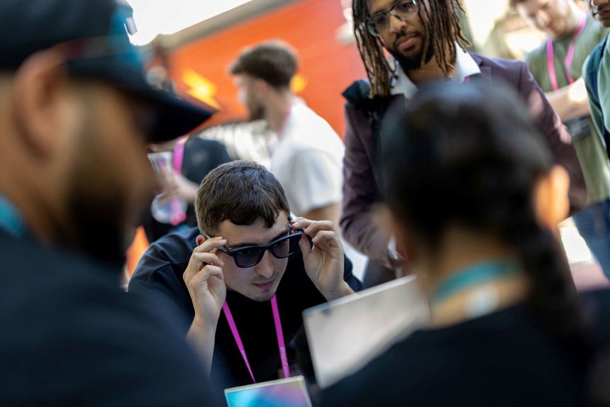 A visitor tries on Meta's new Ray-Ban Gen 2 smart glasses during Meta Connect.