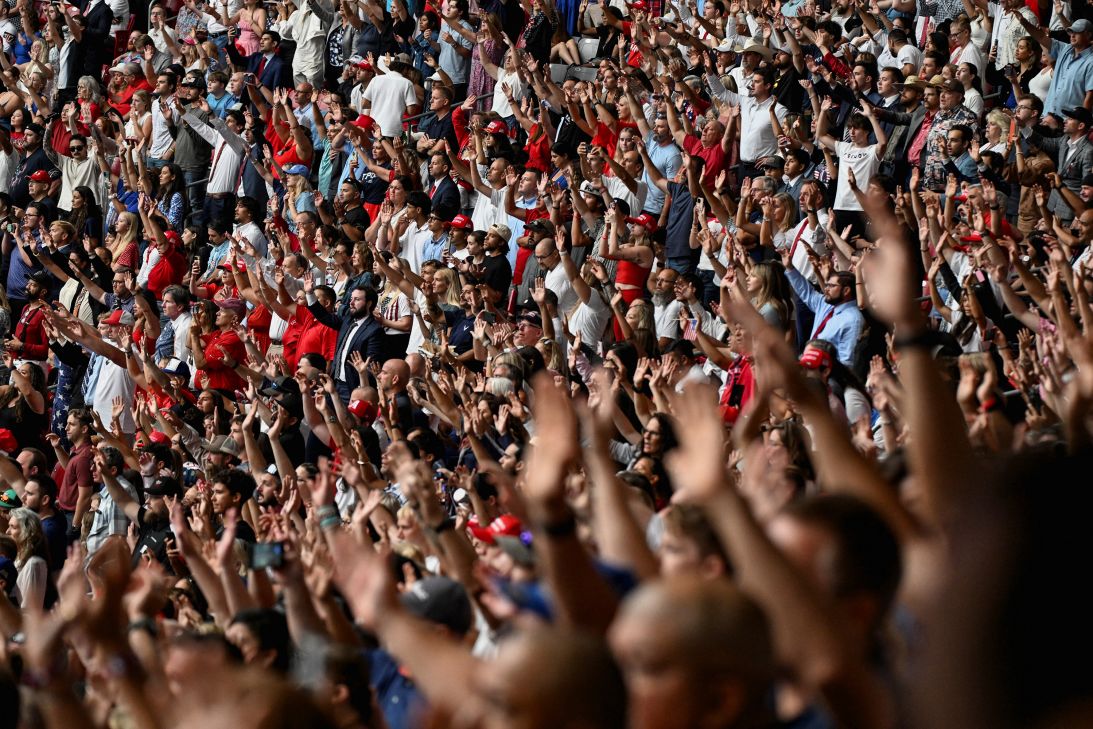 People sing worship songs as they gather to attend Charlie Kirk's memorial service in Glendale, Arizona, on Sunday.