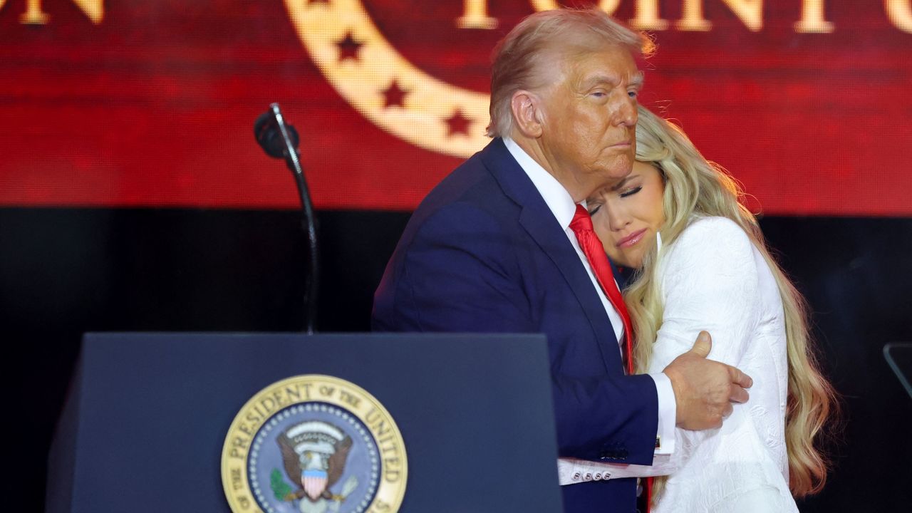 U.S. President Donald Trump embraces Erika Kirk, during a memorial service for her husband, slain conservative commentator Charlie Kirk, at State Farm Stadium in Arizona, U.S., September 21, 2025. REUTERS/Carlos Barria     
