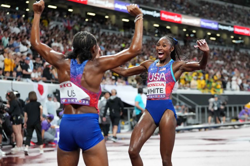 Kayla White (right) and Melissa Jefferson-Wooden celebrate after the United States women's victory in the 4x100m relay.