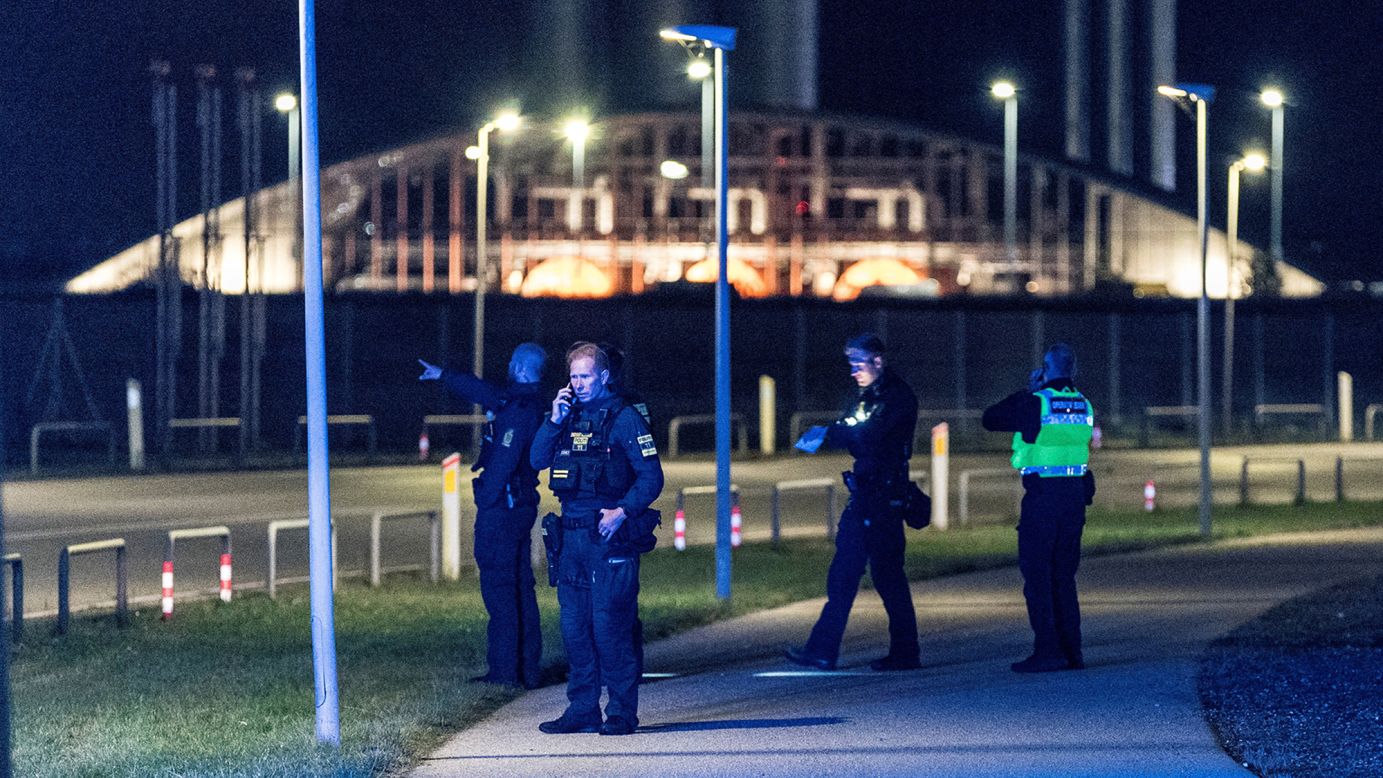 Police officers at Copenhagen Airport, closed due to drone activity.