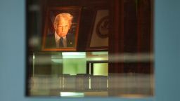 A photograph of President Donald Trump is lit up at the entranceway of Justin W. Williams United States Attorney's building, adjacent to US District Court in Alexandria, Virginia, on Thursday.