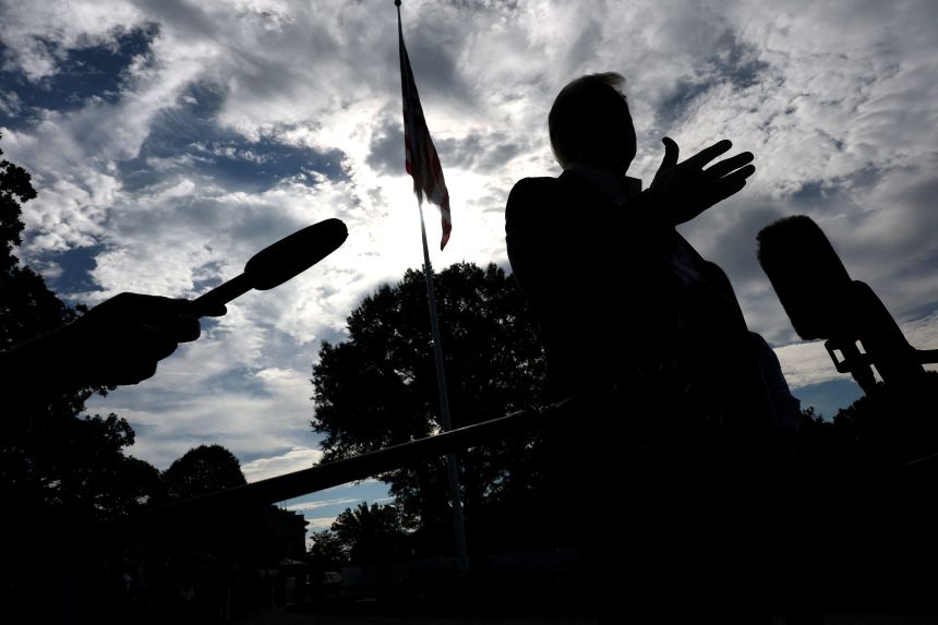 President Donald Trump speaks to the media before departing the White House on Friday.