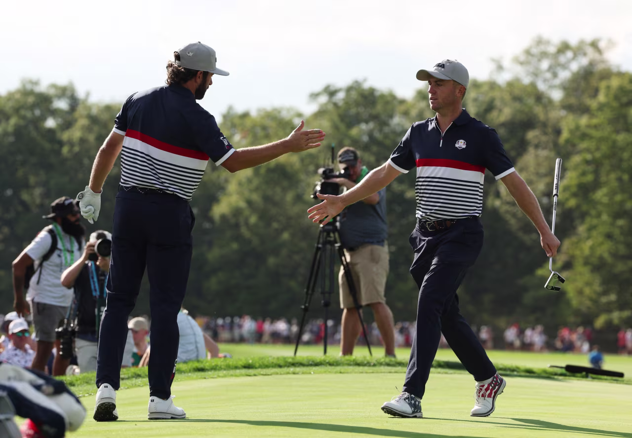 Cameron Young, left, celebrates with Justin Thomas after they won the 11th hole.