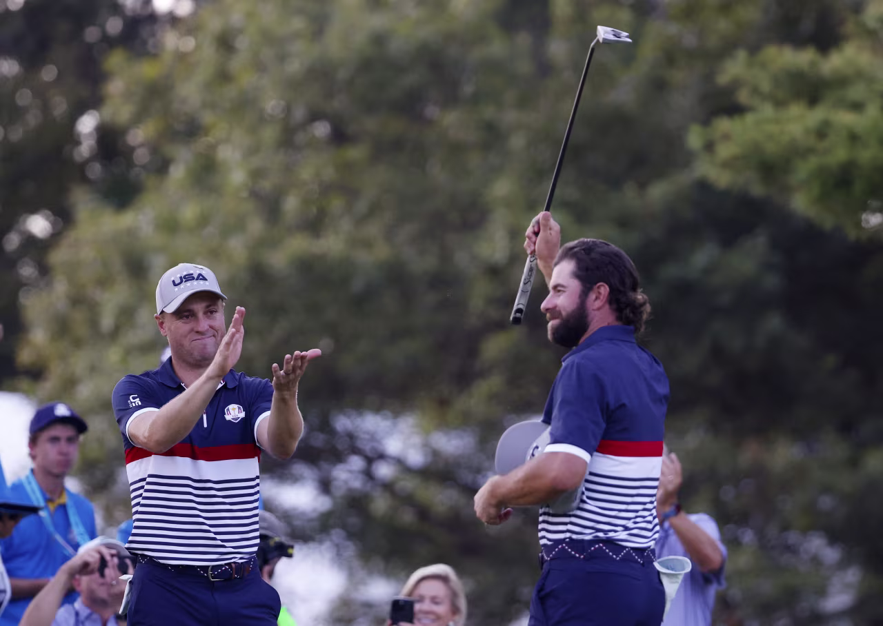 Justin Thomas applauds his teammate Cameron Young after their win on Friday afternoon.