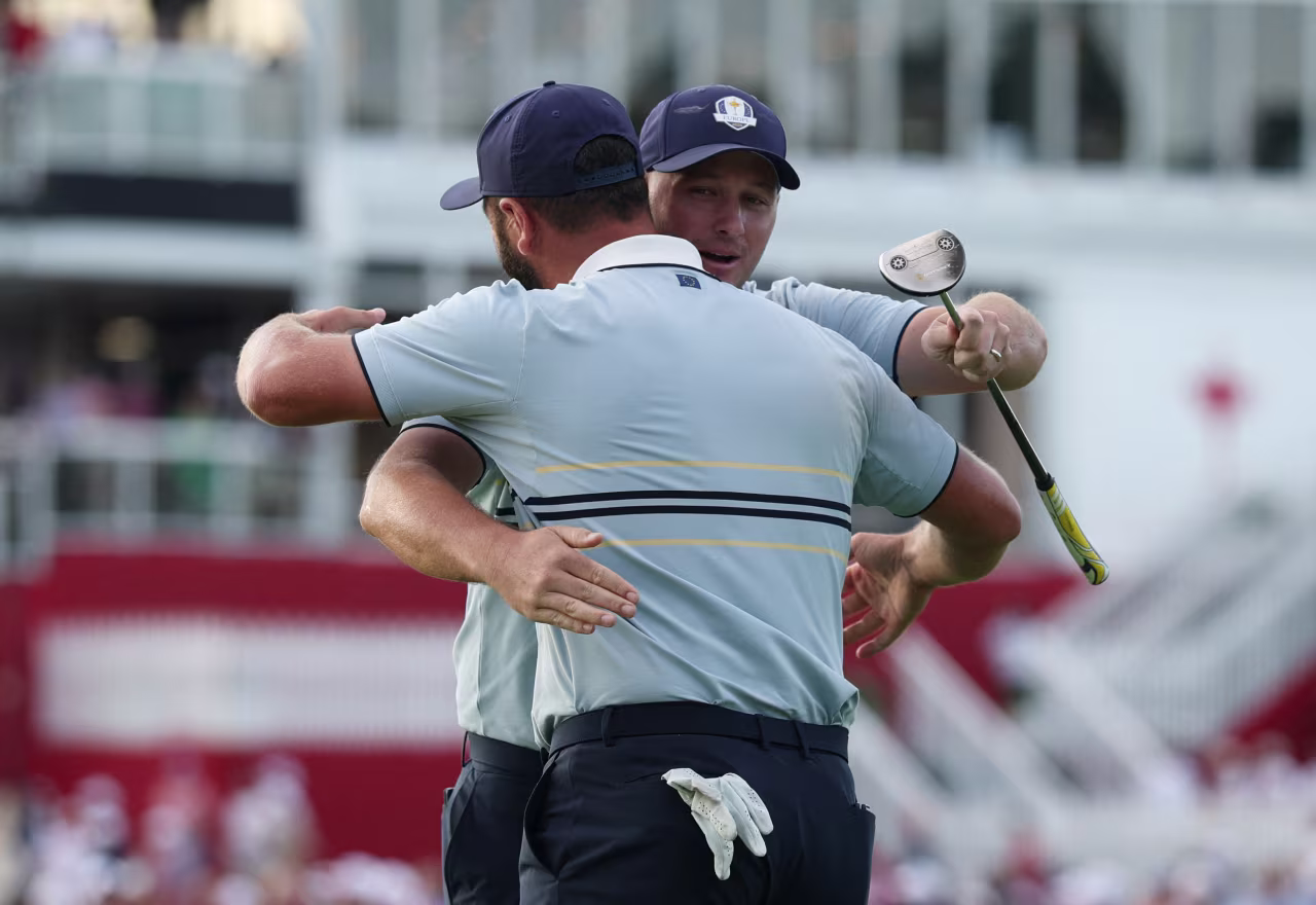 Sepp Straka and Jon Rahm embrace each other after winning their afternoon match on Friday.