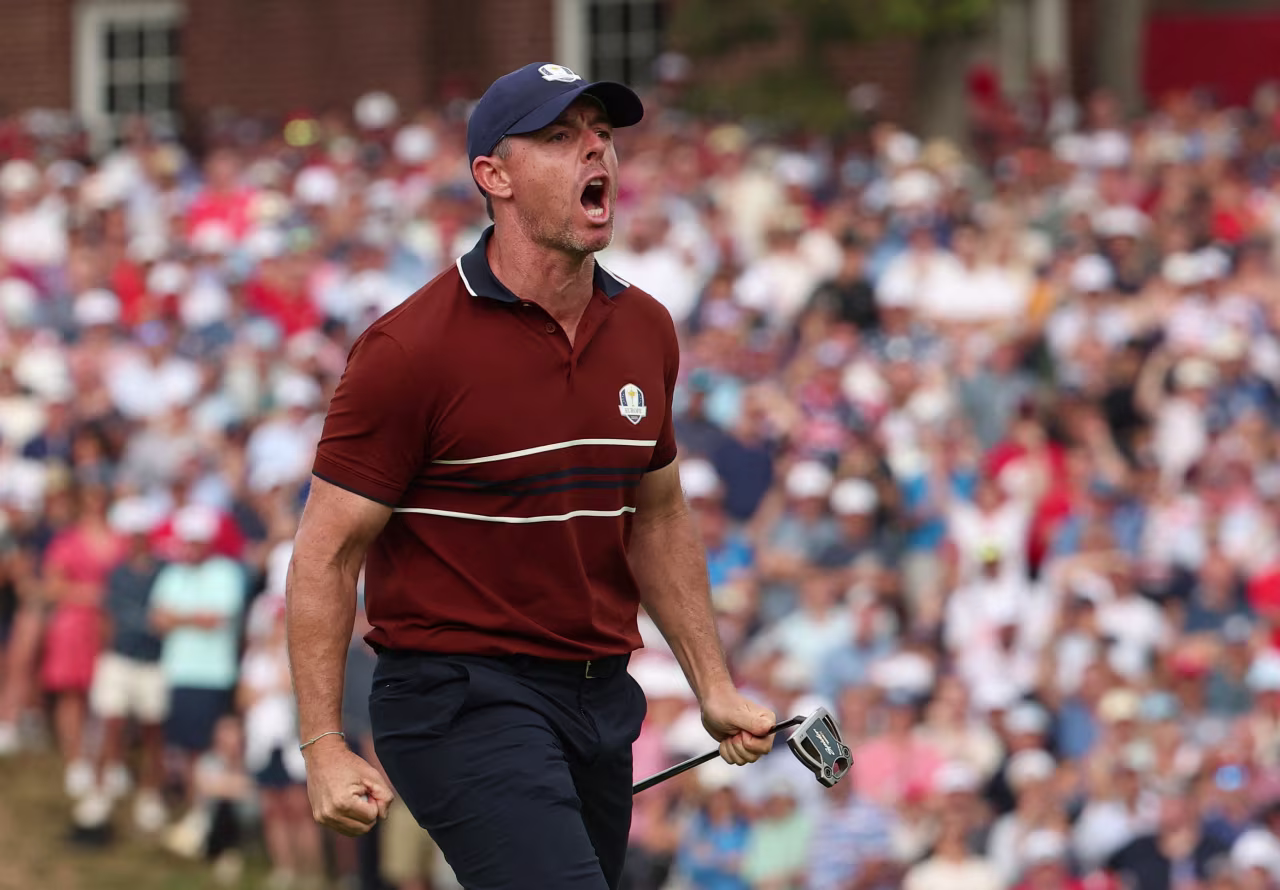 Rory McIlroy celebrates after holing his putt on the 14th hole.