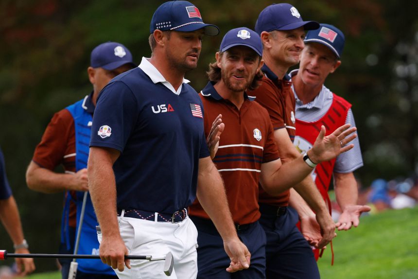 Team Europe's Tommy Fleetwood and Team USA's Bryson DeChambeau argue on the 15th green during the four-balls.
