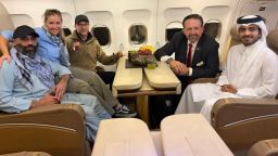 Amir Amiri, left, poses for a picture alongside special envoy for hostage response Adam Boehler (third left), Deputy Assistant to the President Sebastian Gorka (second right), and Qatari diplomats on a plane from Kabul on September 28, 2025.
