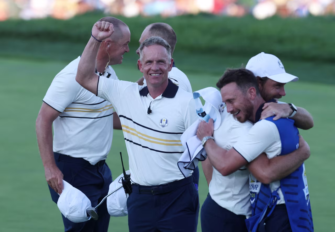 Team Europe captain Luke Donald, center, celebrates after Tyrrell Hatton secured a half-point.