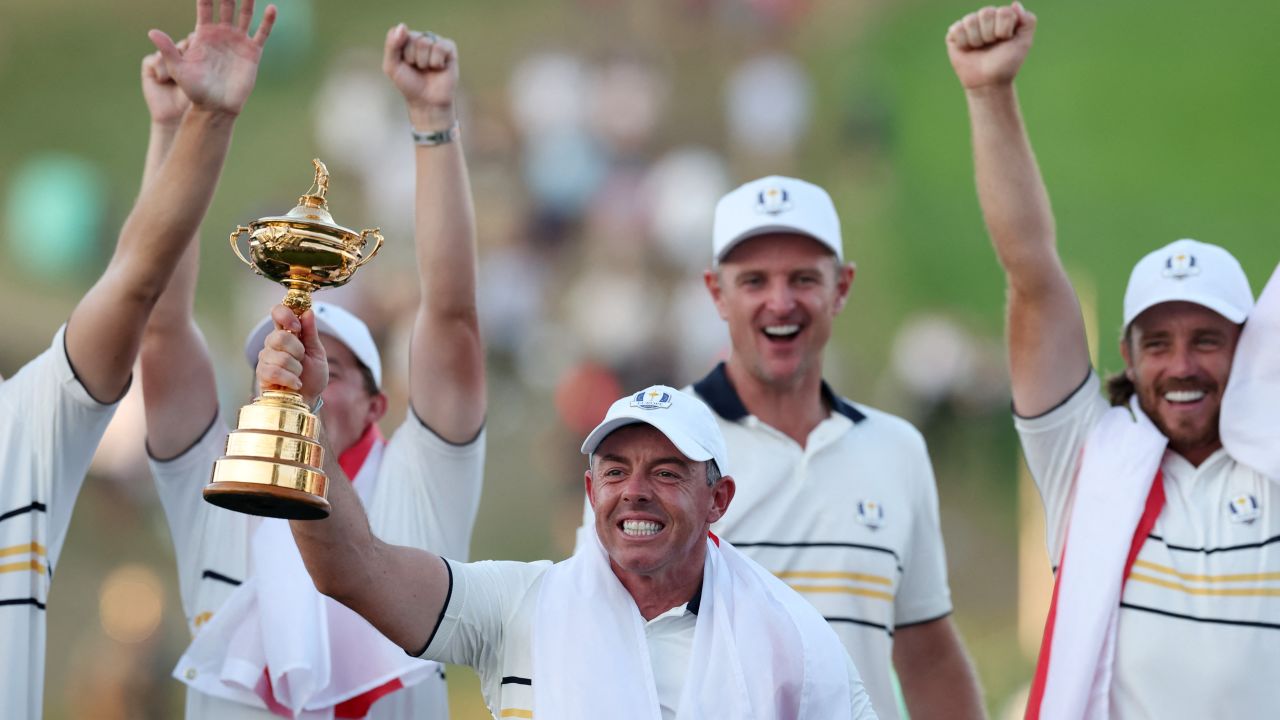 Golf - The 2025 Ryder Cup - Bethpage Black Golf Course, Farmingdale, New York, United States - September 28, 2025 Team Europe's Rory McIlroy celebrates with the trophy after winning the Ryder Cup as Tommy Fleetwood and Justin Rose look on REUTERS/Paul Childs