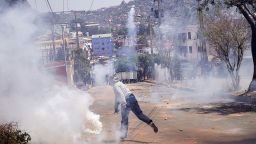 A protester throws back a tear gas canister lobbed by Malagasy riot police during a demonstration denouncing frequent power outages and water shortages, near the University of Antananarivo, Madagascar September 29, 2025. REUTERS/Zo Andrianjafy