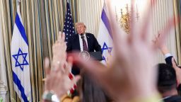 Members of the media raise their hands to ask questions as U.S. President Donald Trump and Israeli Prime Minister Benjamin Netanyahu hold a joint press conference in the State Dining Room at the White House in Washington, D.C., U.S., September 29, 2025. REUTERS/Jonathan Ernst