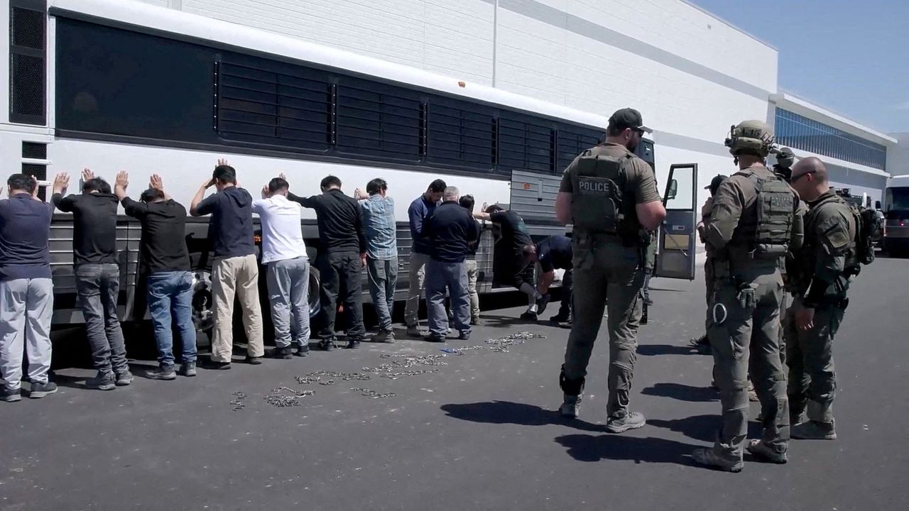 Detainees are made to stand against a bus before being handcuffed, during a raid by federal agents where about 300 South Koreans were among 475 people arrested at the site of a $4.3 billion project by Hyundai Motor and LG Energy Solution to build batteries for electric cars in Ellabell, Georgia, U.S., September 4, 2025 in a still image taken from a video.