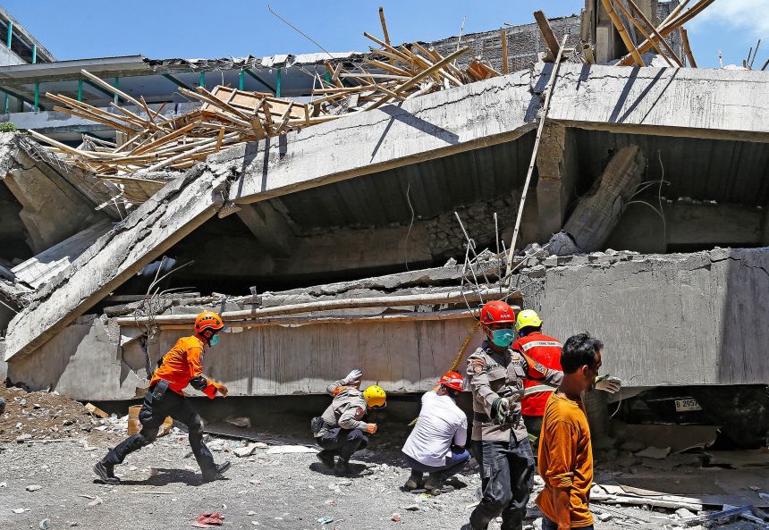 Rescuers search for victims in the rubble of a collapsed boarding school in Sidoarjo, East Java province, Indonesia, on October 1, 2025.