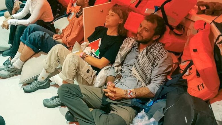 Swedish activist Greta Thunberg and Brazilian activist Thiago Avila sit in a vessel making their way to Israel, after Israel intercepted some of the vessels of the Global Sumud Flotilla aiming to reach Gaza and break Israel's naval blockade, in this handout image released on October 2, 2025.