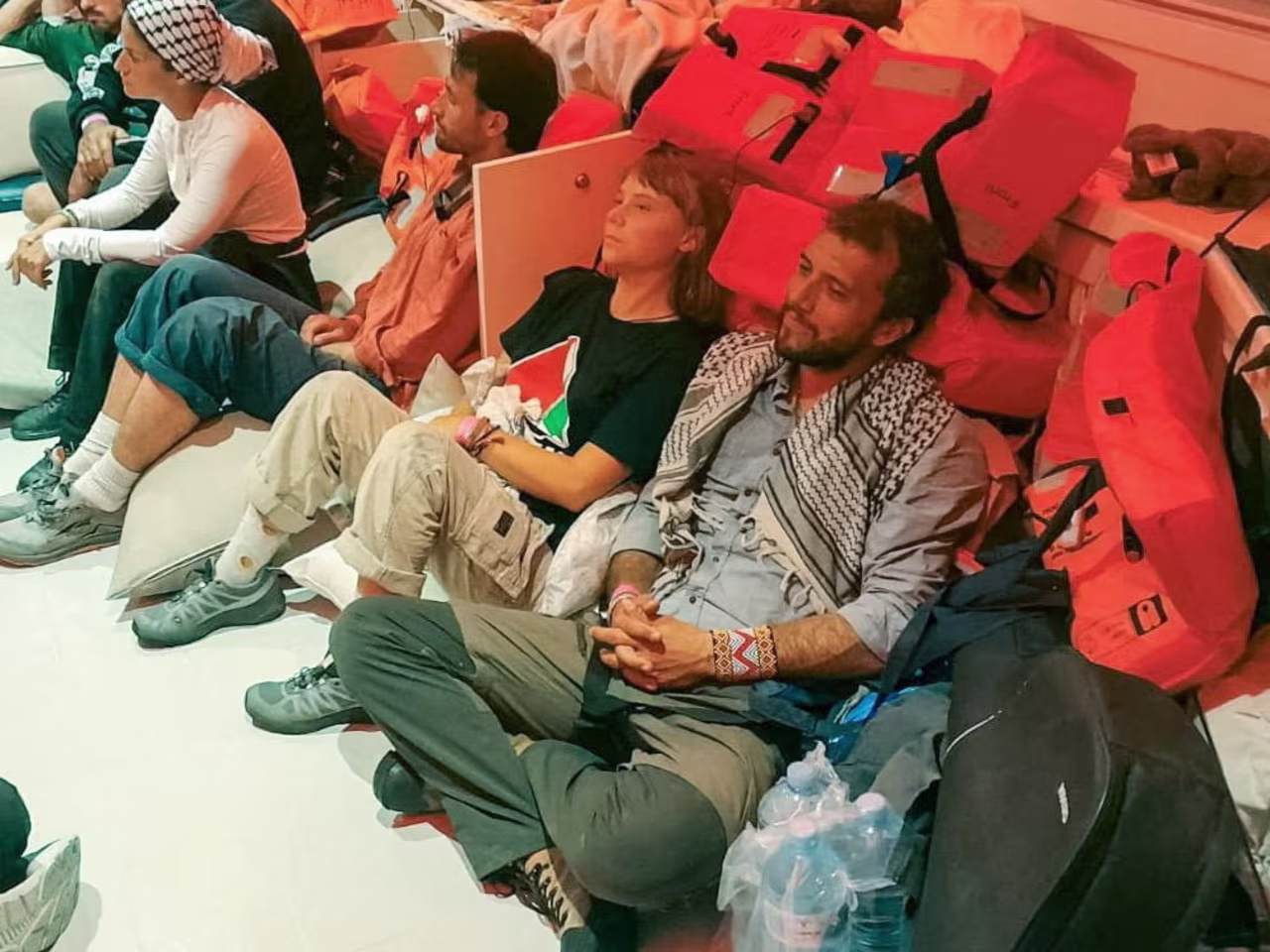 Swedish activist Greta Thunberg and Brazilian activist Thiago Avila sit in a vessel making their way to Israel, after Israel intercepted some of the vessels of the Global Sumud Flotilla aiming to reach Gaza and break Israel's naval blockade, on October 2, 2025.