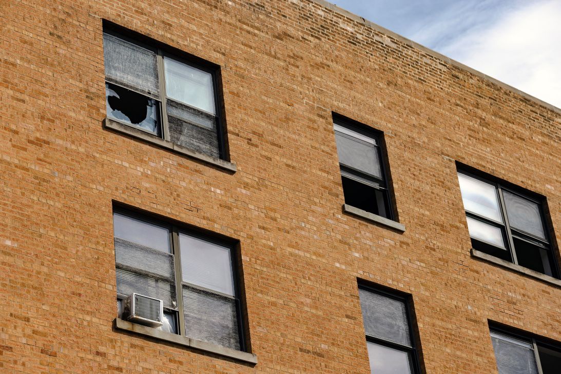 Several exterior windows of a South Shore apartment complex were seen broken in the aftermath of a large scale ICE raid on September 30.