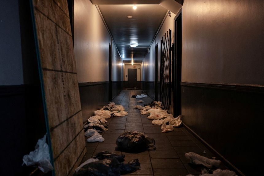 Debris and personal items belonging to Venezuelan immigrants sit in the hallway of an apartment complex in Chicago on October 2, after an ICE raid days earlier.
