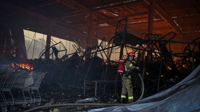A firefighter works at the site of a Russian drone and missile strikes, amid Russia's attack on Ukraine, in Lviv, Ukraine on October 5, 2025.