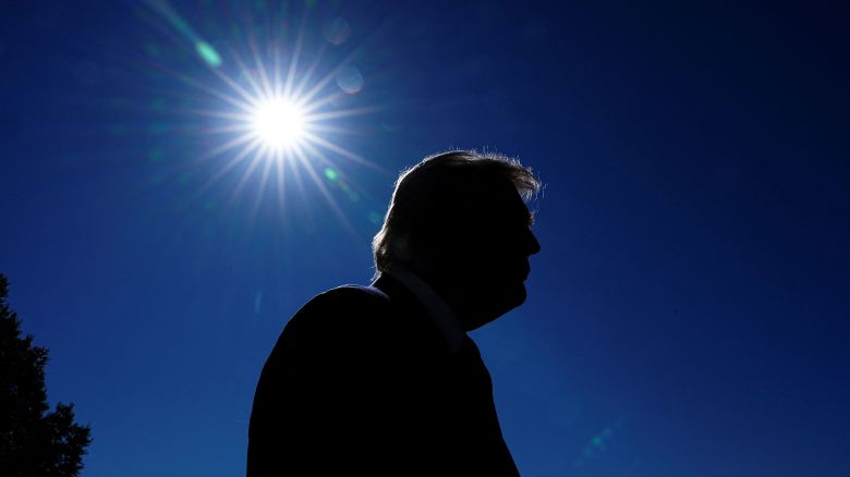 U.S. President Donald Trump is silhouetted as he departs the White House en route to Norfolk, Virginia to attend the 250th Anniversary of the Navy celebration, from the South Lawn at the White House in Washington, D.C., U.S., October 5, 2025. REUTERS/Aaron Schwartz
