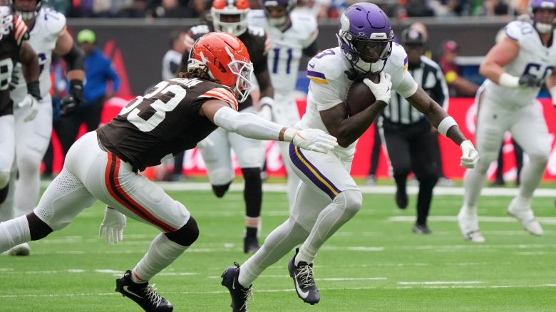Oct 5, 2025; Tottenham, United Kingdom; Minnesota Vikings wide receiver Jordan Addison (3) runs with the ball against Cleveland Browns safety Ronnie Hickman Jr. (33) during the third quarter of an NFL International Series game at Tottenham Hotspur Stadium. Mandatory Credit: Kirby Lee-Imagn Images