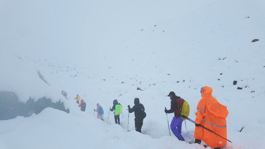 Trekkers leave their campsite in Tibet, China, as unusually heavy snow and rainfall pummeled the region, October 5, 2025.