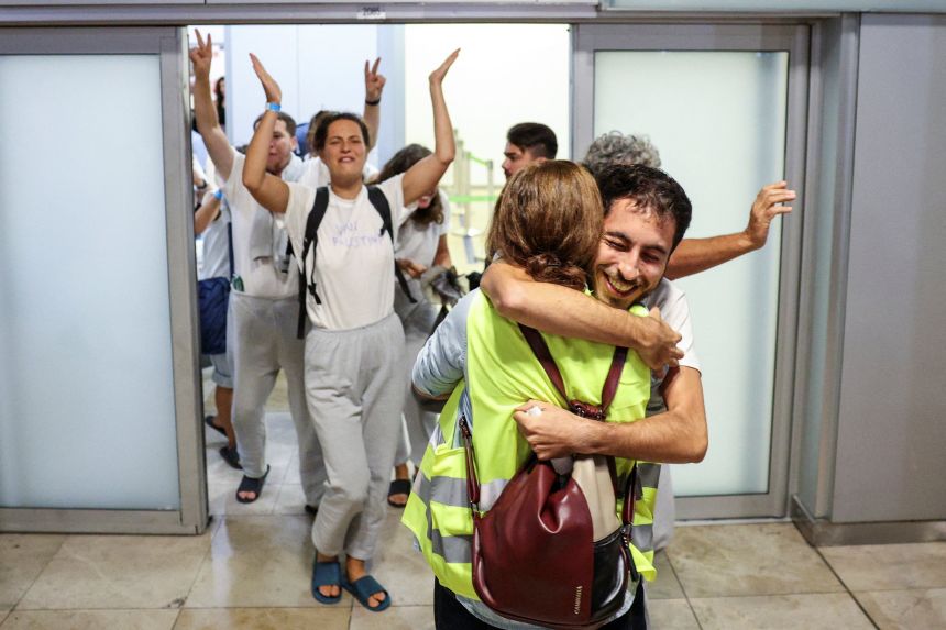 The deported activists were greeted by relatives and supporters at the airport in Madrid on October 5, 2025.