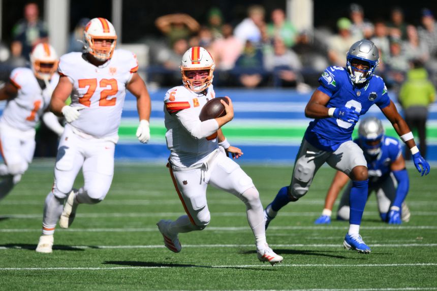 Tampa Bay Buccaneers quarterback Baker Mayfield scrambles against the Seattle Seahawks in the first half at Lumen Field.