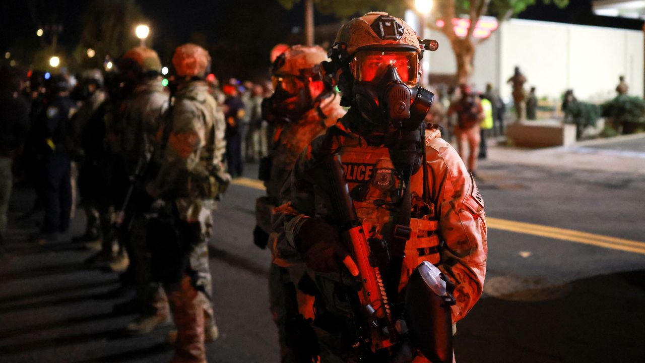 Law enforcement officers stand guard outside the U.S. Immigration and Customs Enforcement (ICE) headquarters, after U.S. District Judge Karin Immergut on Sunday temporarily blocked U.S. President Donald Trump's administration from sending any National Guard troops to police Portland, in south Portland, Oregon, U.S., October 5, 2025.