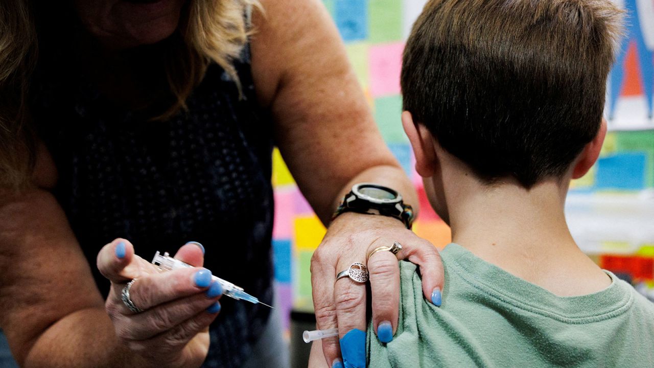 A child receives a dose of the Moderna coronavirus disease vaccine at Skippack Pharmacy in Schwenksville, Pennsylvania, on September 11.