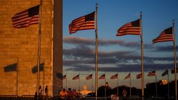 People watch the sunset from the Washington Monument ahead of the first supermoon of the year, known as the Harvest Moon, rising above the National Mall, in view of the dome of the U.S. Capitol during the sixth day of a shutdown of the federal government in Washington, D.C., U.S., October 6, 2025.