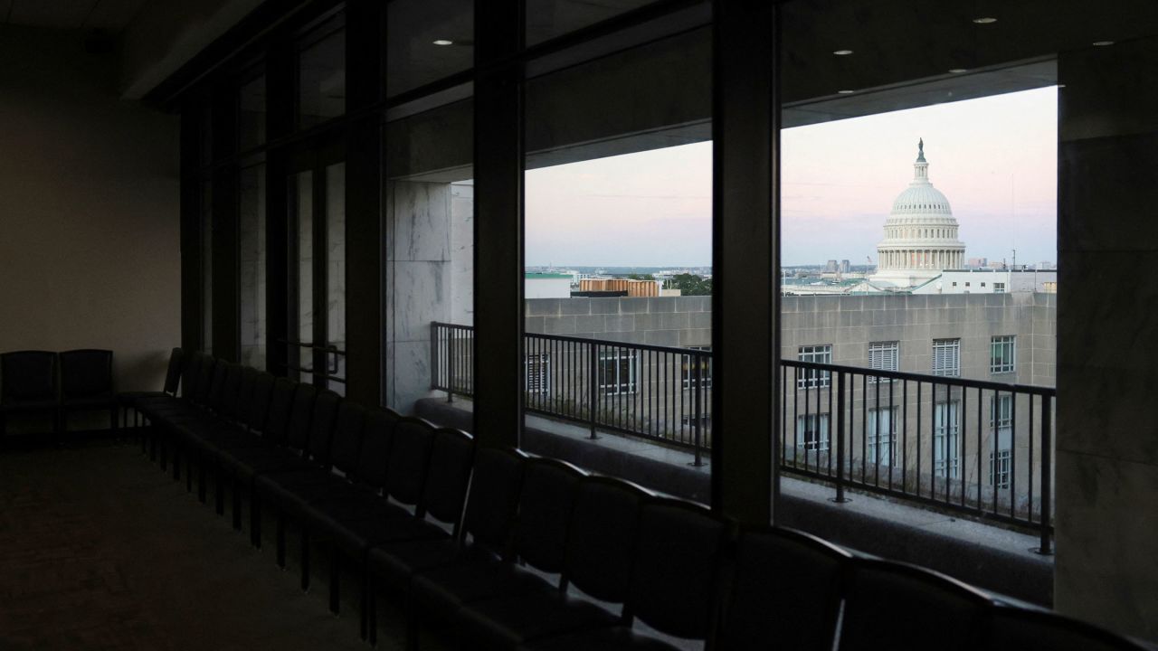 Dawn brightens the sky over the U.S. Capitol dome, seen from an empty meeting room during the continuing partial federal government shutdown in the Hart Senate Office Building on Capitol Hill in Washington, D.C., U.S., October 7, 2025. REUTERS/Jonathan Ernst