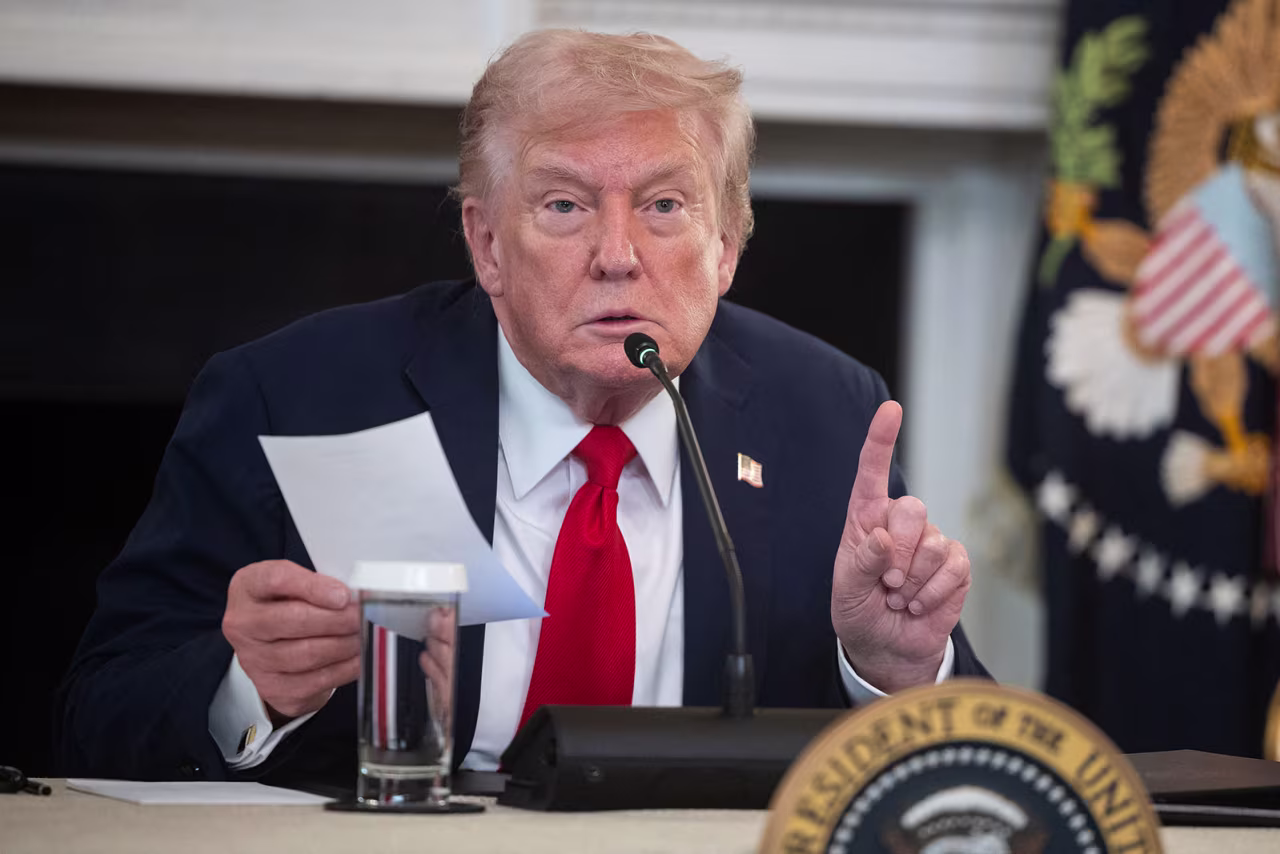 President Donald Trump holds a note from Secretary of State Marco Rubio as he speaks during an event in the State Dining Room at the White House on Wednesday.