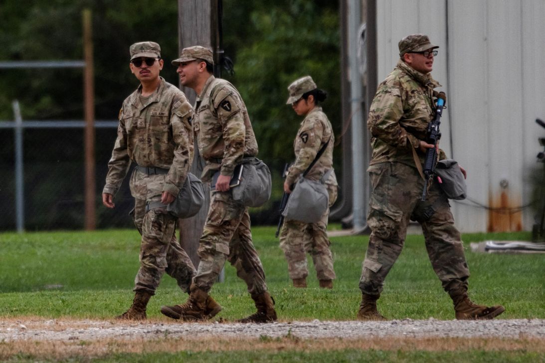 Texas National Guard troops walk through the Joliet Army Reserve Training Center in Elwood, Illinois.