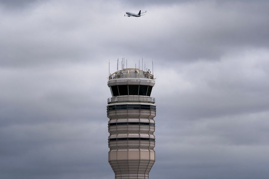 A flight takes off past the air traffic control tower at Reagan Washington National Airport, on October 8.
