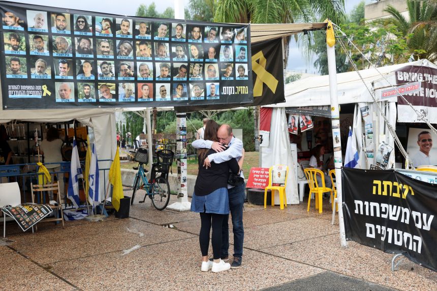 People hug in "Hostages Square" in Tel Aviv, Israel, on Thursday.