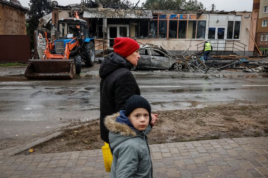 People pass buildings damaged during a Russian drone and missile attack in the town of Brovary, Kyiv region, on Friday.
