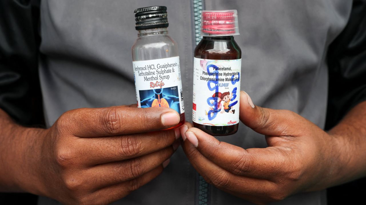 Saddam Mansuri, a father of two, holds up bottles of Coldrif and Relife cough syrup in Parasia, Madhya Pradesh, India, on October 10, 2025.