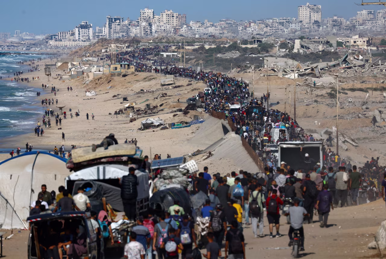 Displaced Palestinians make their way along a road as they return to northern Gaza on Friday.