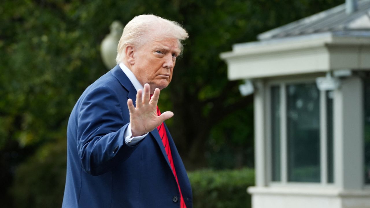 US President Donald Trump waves as he arrives at the White House, following his annual physical exam at Walter Reed National Military Medical Center, in Washington, DC on October 10, 2025.
