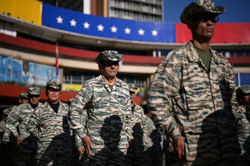 Members of the Bolivarian militia stand in line during military training amid heightened tensions with the United States in Caracas, Venezuela, October 11, 2025.