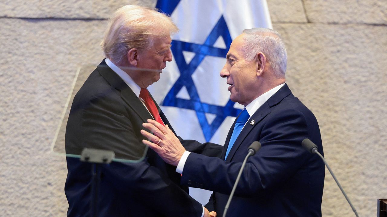 US President Donald Trump and Israeli Prime Minister Benjamin Netanyahu shake hands at the Knesset on the day Trump addresses it, in Jerusalem, on October 13.