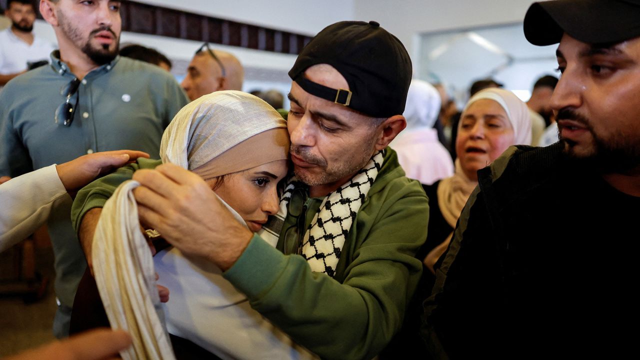 A freed Palestinian is hugged by a relative after he was released from an Israeli jail as part of a hostages-prisoners swap and a ceasefire deal in Gaza between Hamas and Israel, in Ramallah, in the Israeli-occupied West Bank, October 13, 2025. REUTERS/Ammar Awad