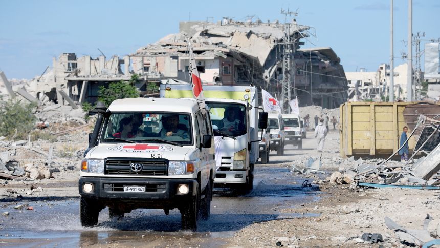 Red Cross vehicles escort a truck transporting the bodies of Palestinians that had been held in Israel during the war.